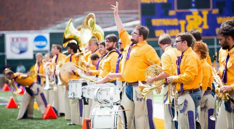 HSU band performing halftime show on football field