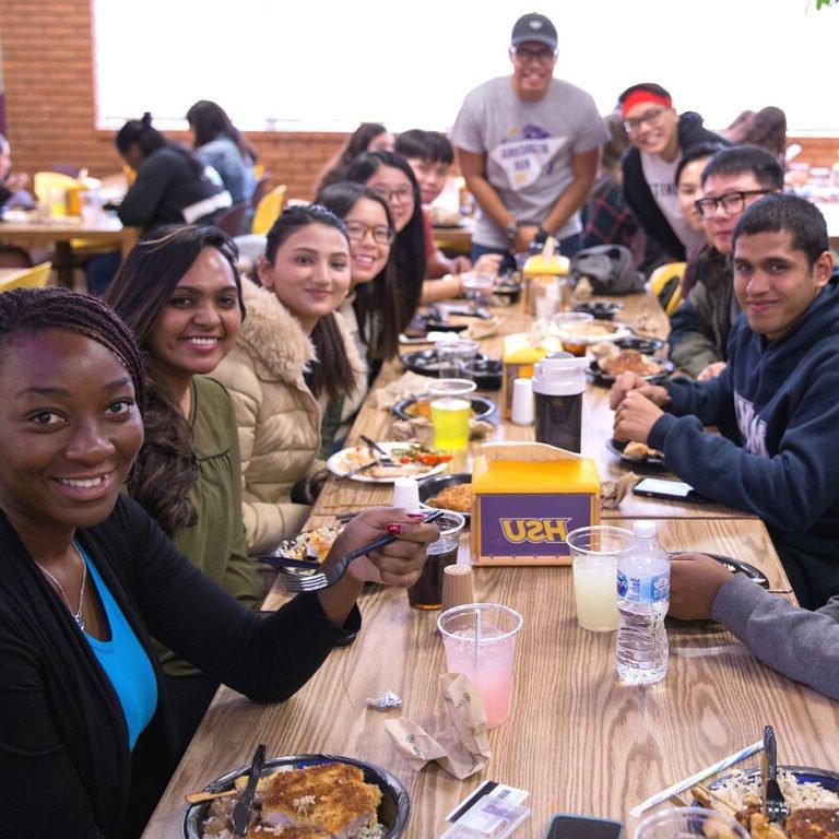 Photo of Internationals students eating together in cafeteria