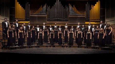 The HSU Concert Choir stands at attention onstage.