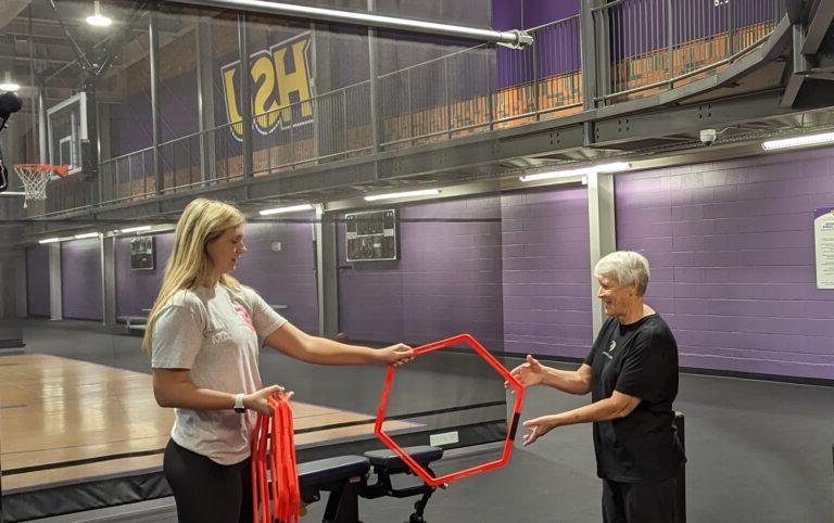 Ava Dennis and Dr. Lorraine Wilson go through a balance and stabilization exercise.